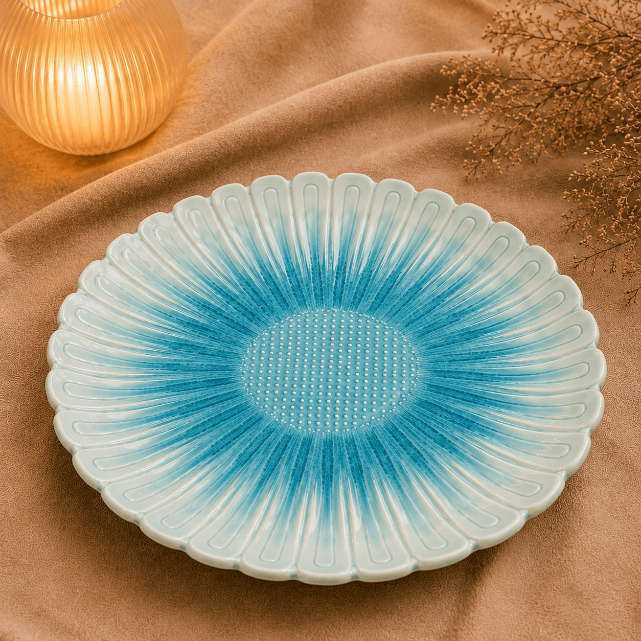 Blauwe keramische lotusschaal van 30 cm op beige stof in een warme sfeersetting met zachte verlichting.