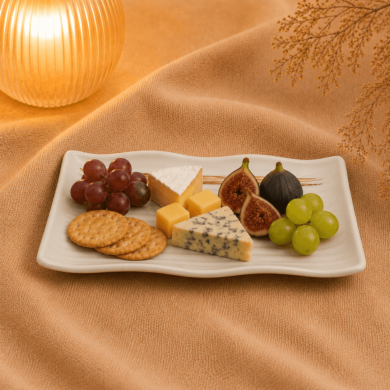 Rechthoekige schaal mat wit 26 cm gevuld met kaas, crackers, druiven en vijgen op een warme beige ondergrond.