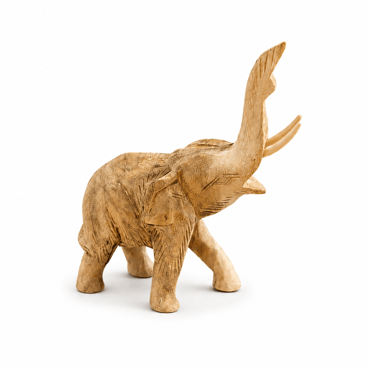 Kleine handgesneden houten olifant met opgeheven slurf tegen een lichte achtergrond.